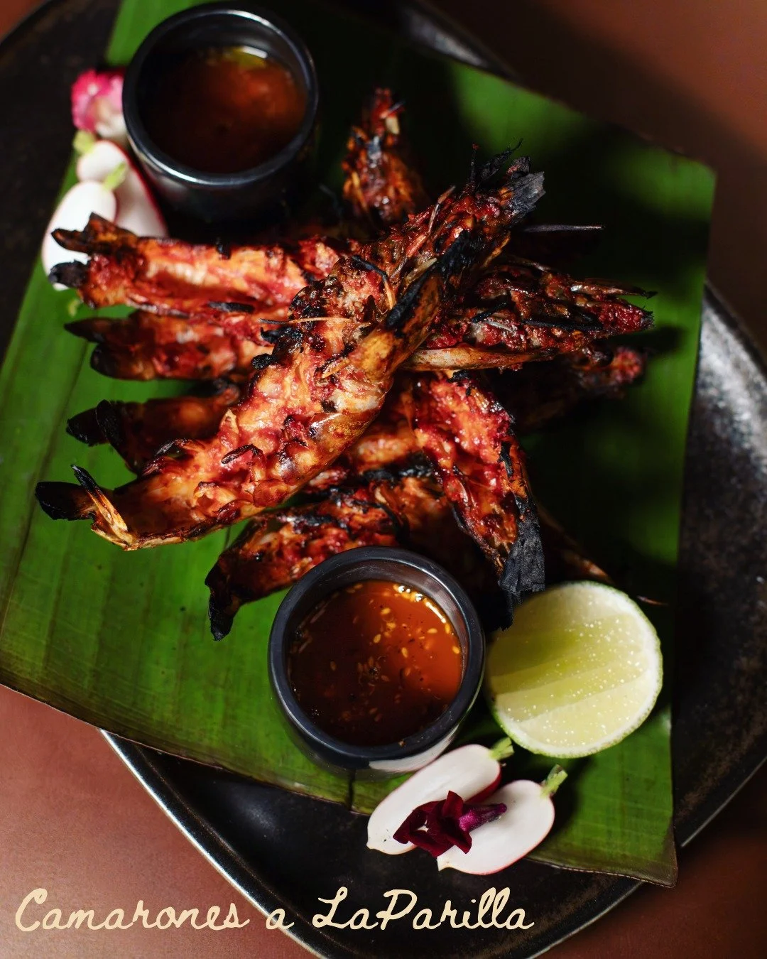Fire-Kissed camarones, straight off the grill 😘🔥🦐

Marinated in our house fermented chili adobo,Charred to perfection, kissed by smoke, and served with our salsa macha and salsa bruja - a flavor that tells a story as deep as its heat.

Originating