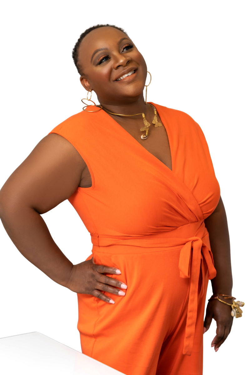 Women with dark skin, short braided hair, wearing orange sleeveless dress, gold jewelry, smiling confidently, standing with hand on hip.