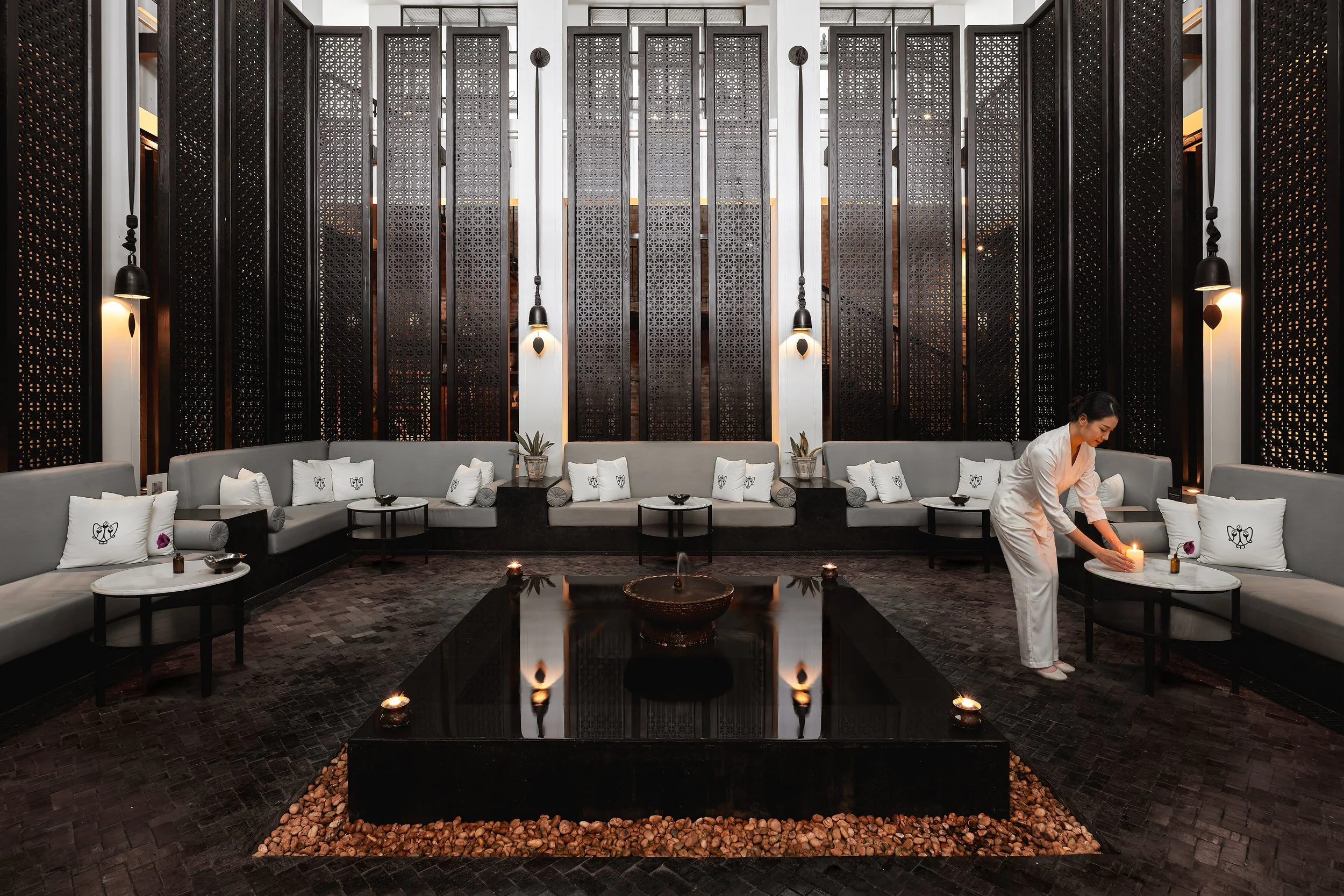 A luxury spa reception with a gracious spa therapist performing tea service in the Wide Asia Region.