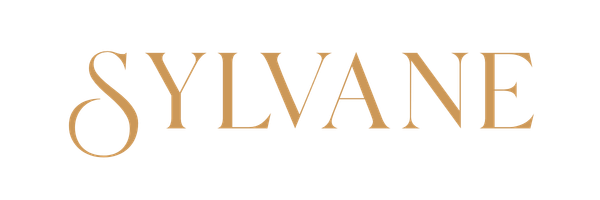 The word "SYLVANE" written in large, stylized font with a decorative design above the "Y" and gold accents on the letters.