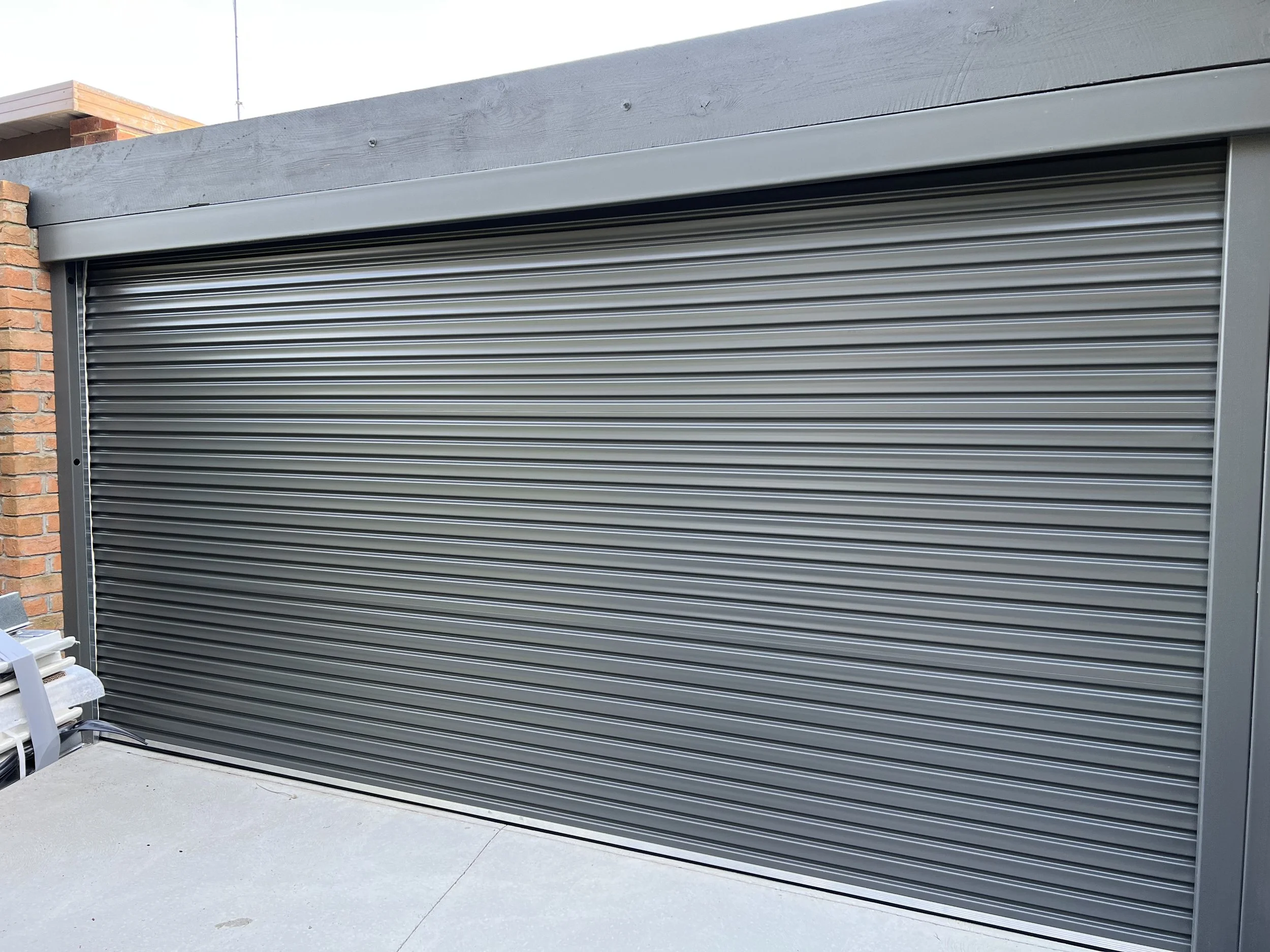 Gray metal roll-up garage door installation