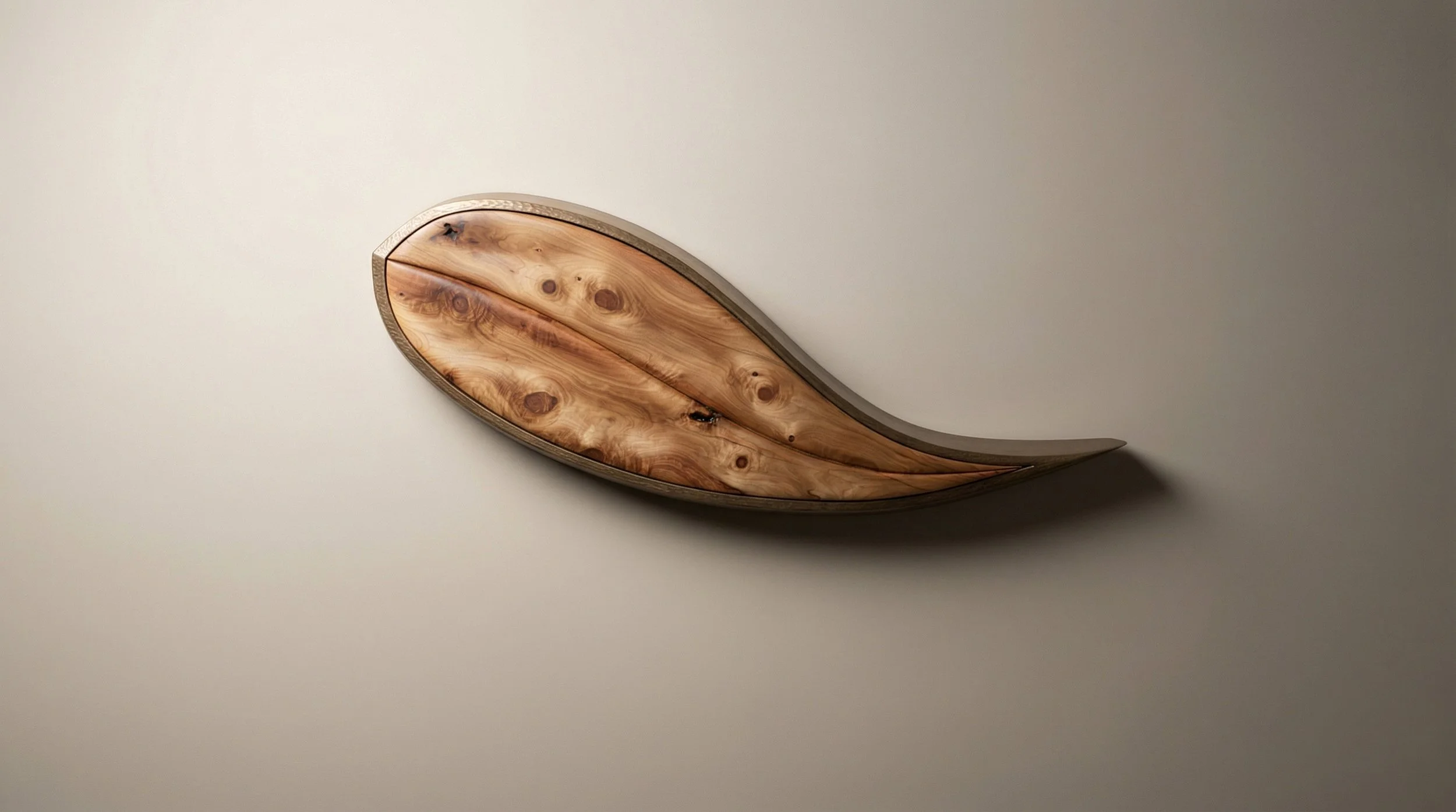 A leaf shaped wood sideboard with gold framing floating on a wall designed and built by Will Marx