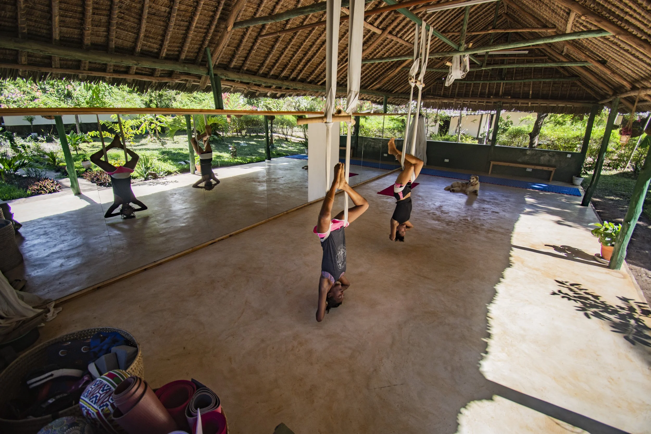 Kaya and Nicole Hankar together at House of Afya with guests practicing aerial yoga.
