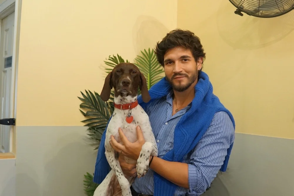 Santiago Jaramillo-Angel holding a brown and white dog