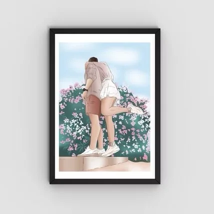 A framed photo of a couple standing on a ledge with a backdrop of pink flowers and a blue sky, with the woman leaning on the man's shoulder.