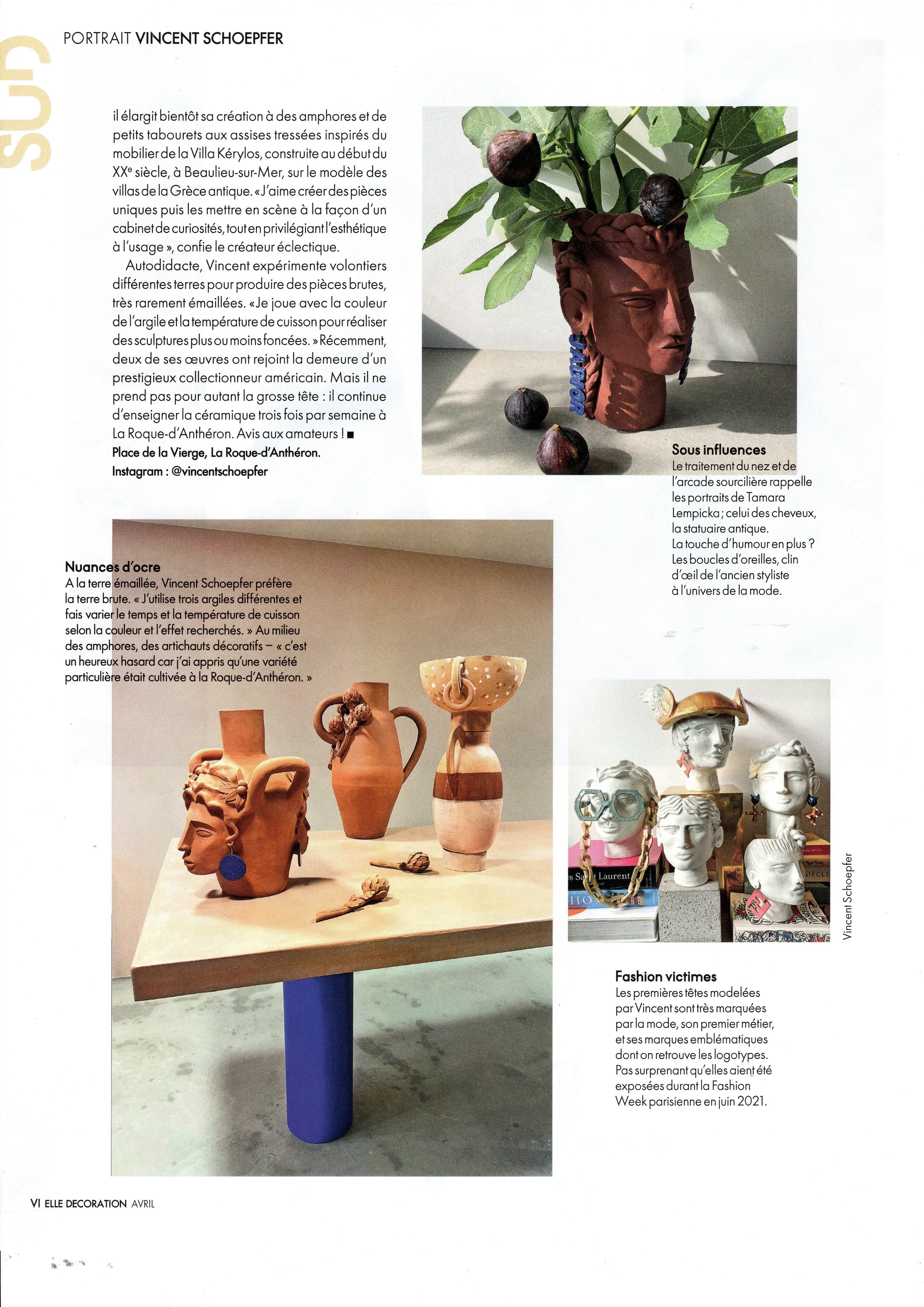 Photo of human head sculptures and other decorative objects on display during Paris Fashion Week in June 2021, arranged in an artistic display.