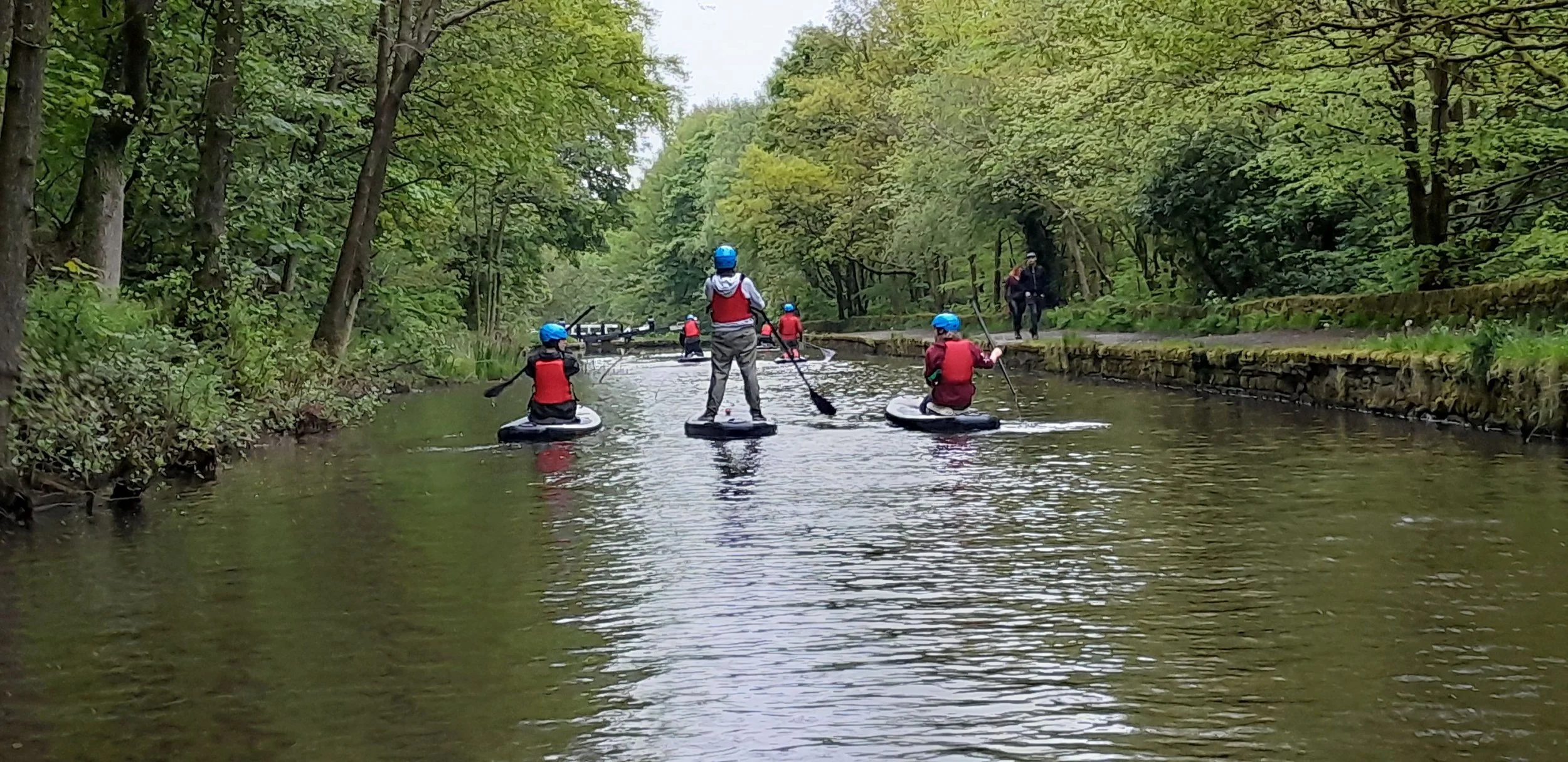 Canoeing along a stretch of the Huddersfield Narrow Canal in Marsden, West Yorkshire.