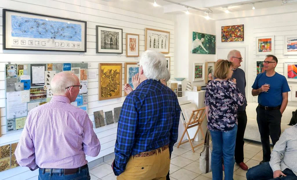 People enjoying a display of art at Enjoy Art in Marsden, West Yorkshire.