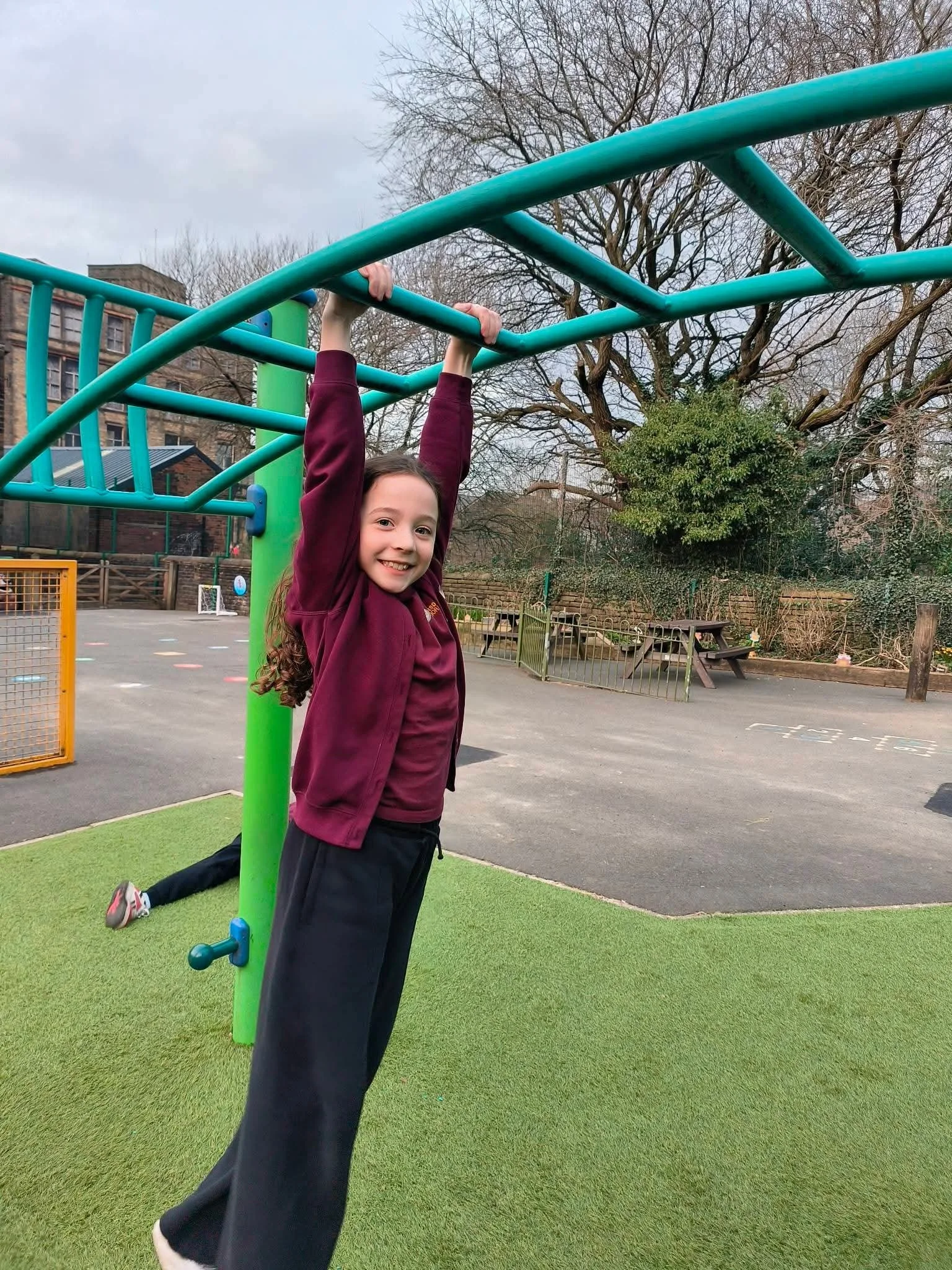 A child playing outside at Marsden Kids' Club in Marsden, West Yorkshire.
