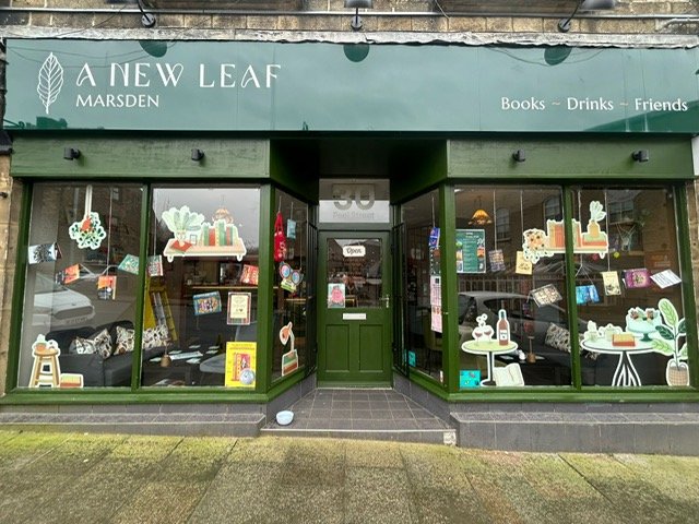The shopfront and window displays of A New Leaf Bookshop in Marsden, West Yorkshire.