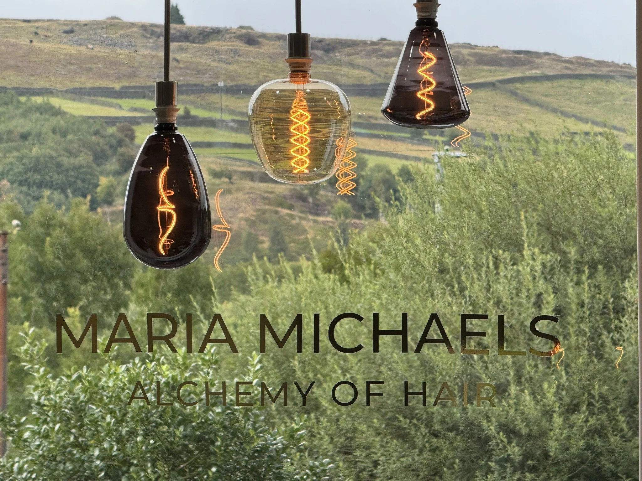 The window and feature lights of Maria Michaels Alchemy of Hair in Marsden, West Yorkshire.