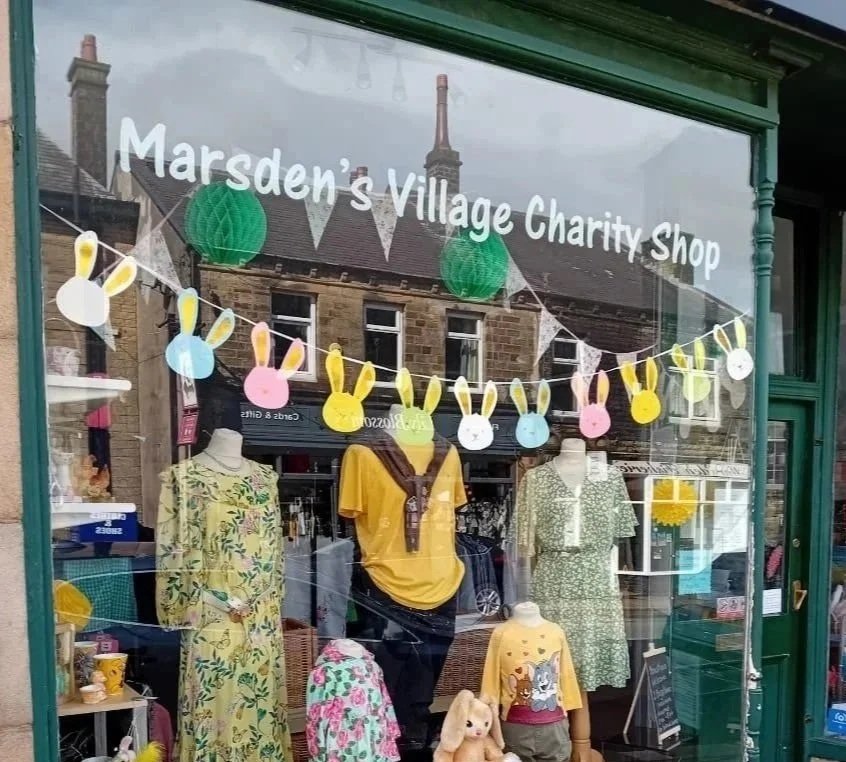 The front window display of the Cuckoo's Nest charity shop in Marsden, West Yorkshire.