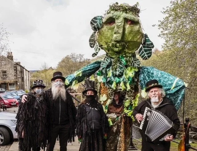 The Green Man puppet and members of the Thieving Magpies in Marsden, West Yorkshire.
