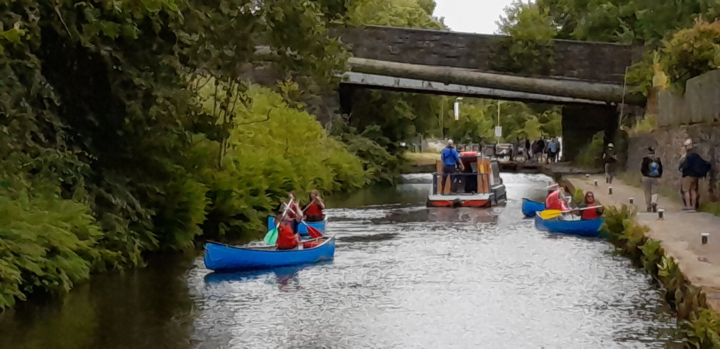 People canoeing along the Huddersfield Narrow Canal in Marsden, West Yorkshire.