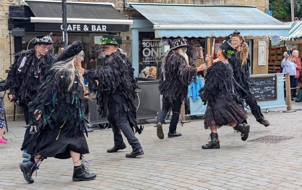 Members of the West Yorkshire-based Thieving Magpie Border Morris group dancing.
