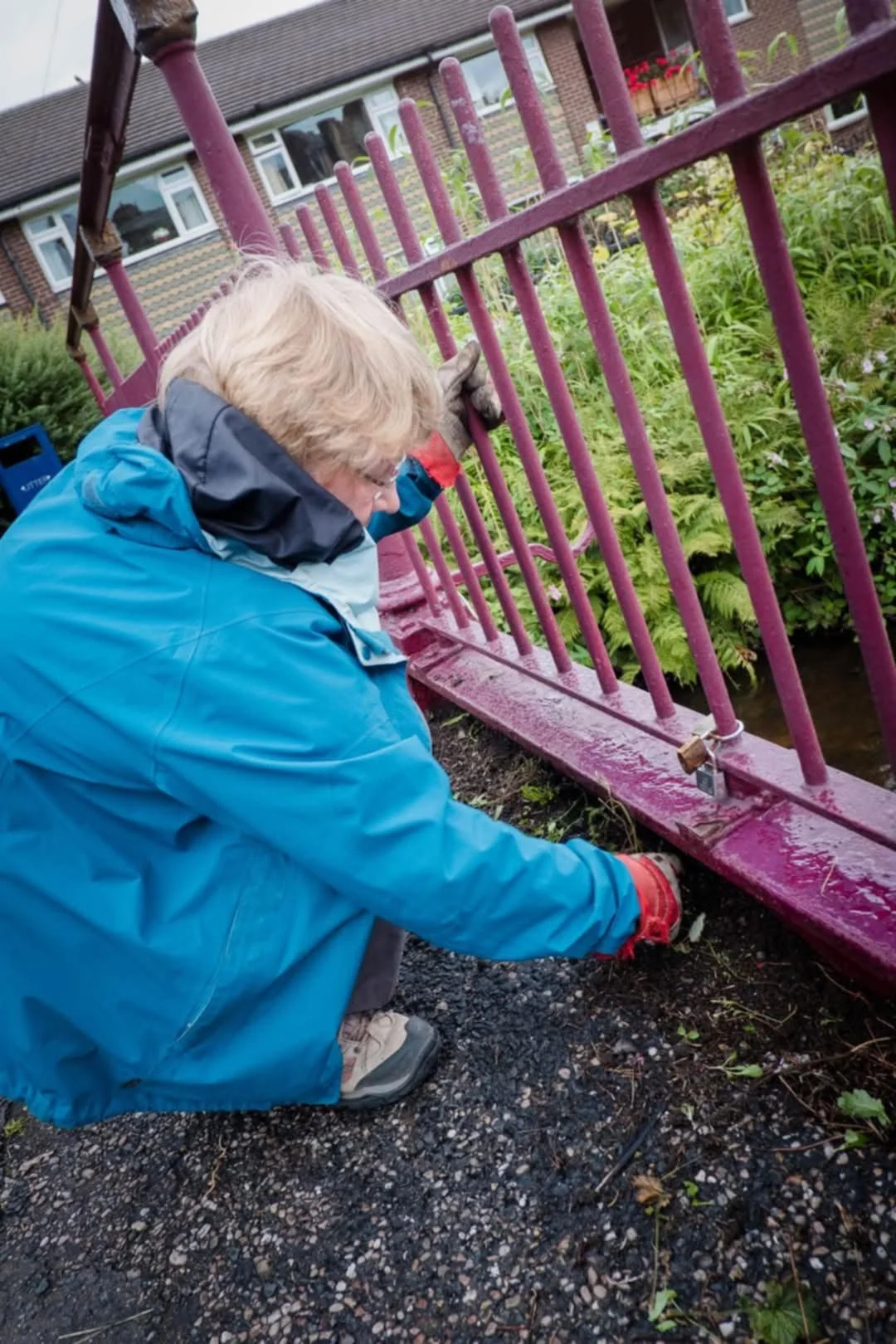 A volunteer painting railings in Marsden, West Yorkshire.