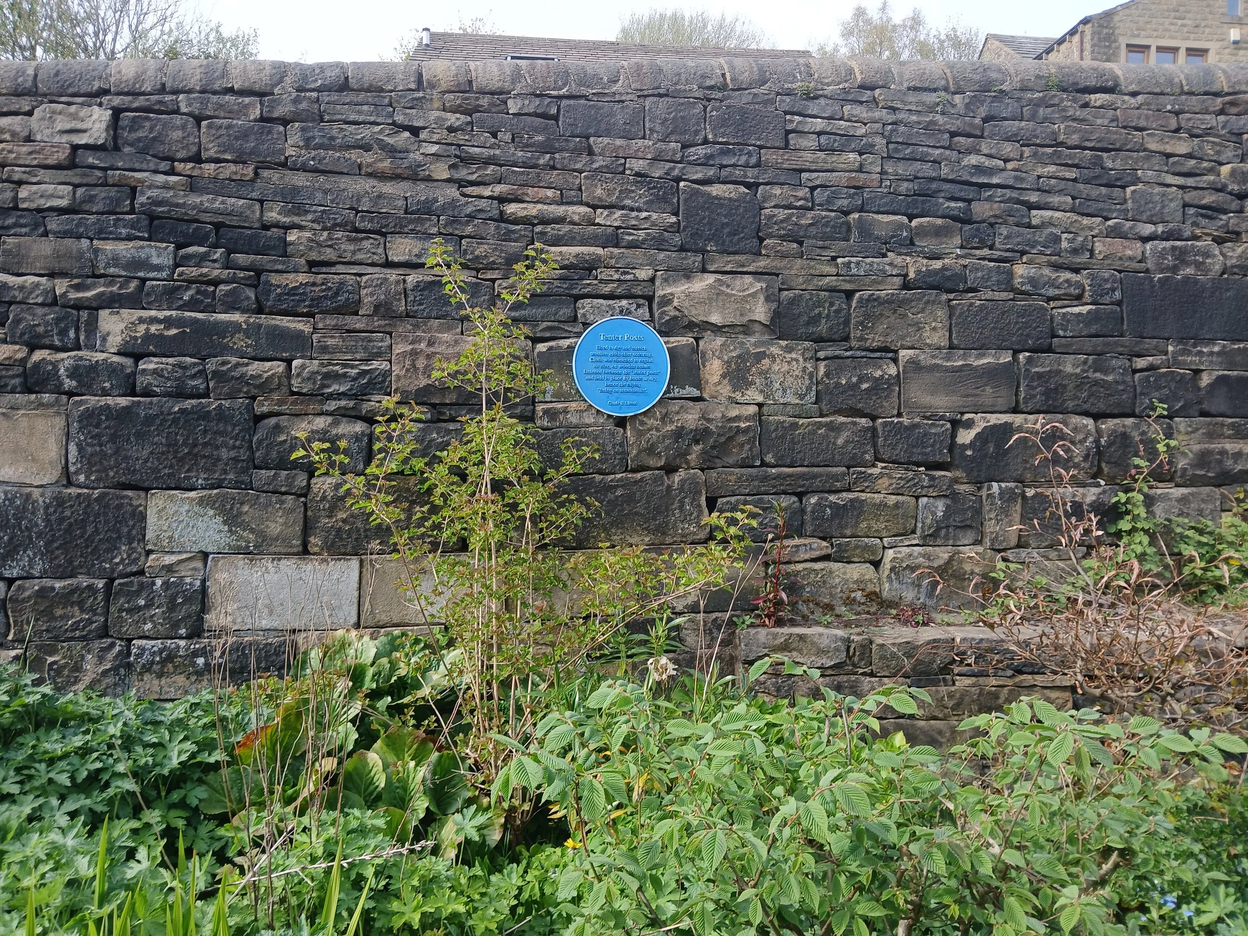 The blue plaque near the tenter posts in Marsden, West Yorkshire.