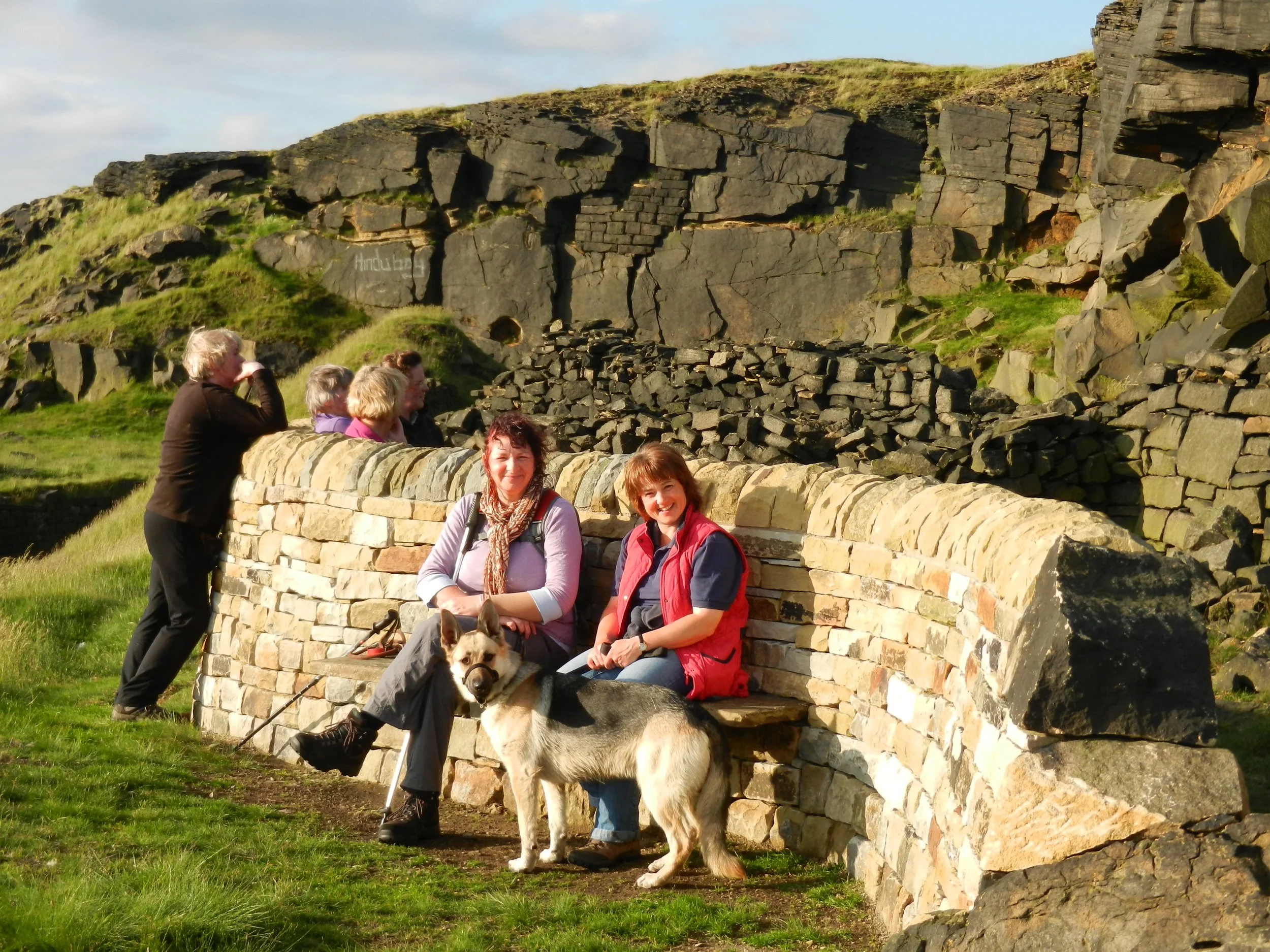 People gathered around the 'Snow' Stanza Stone on the Stanza Stones Poetry Trail.