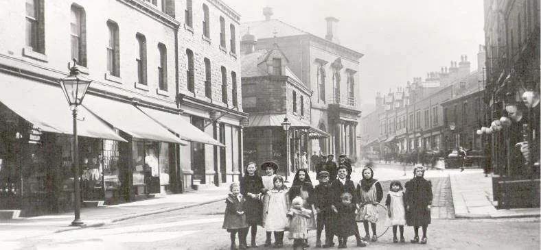 An old photograph of children standing in the high street of Marsden, West Yorkshire.