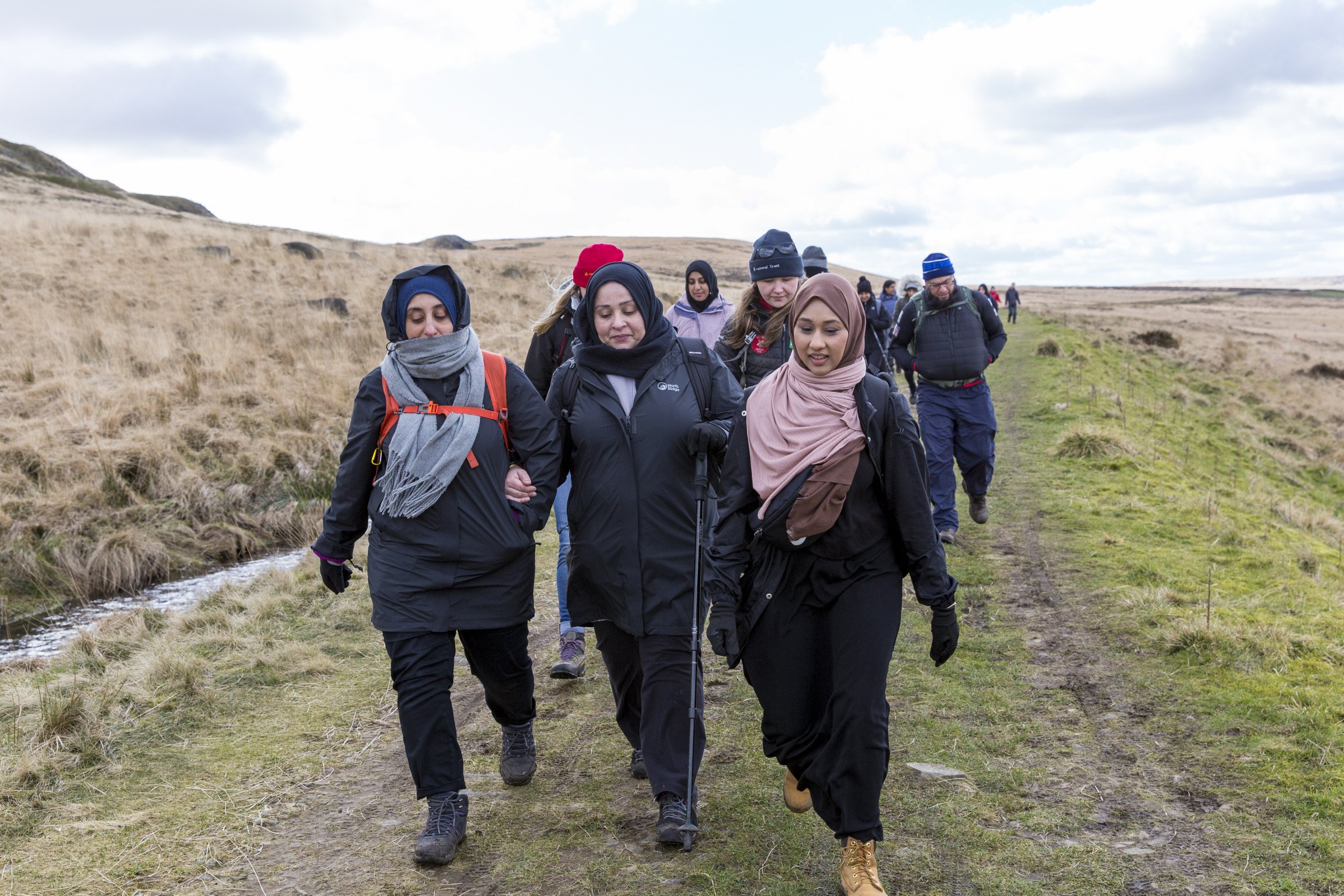 A group of walkers enjoying a National Trust guided walk in Marsden, West Yorkshire.