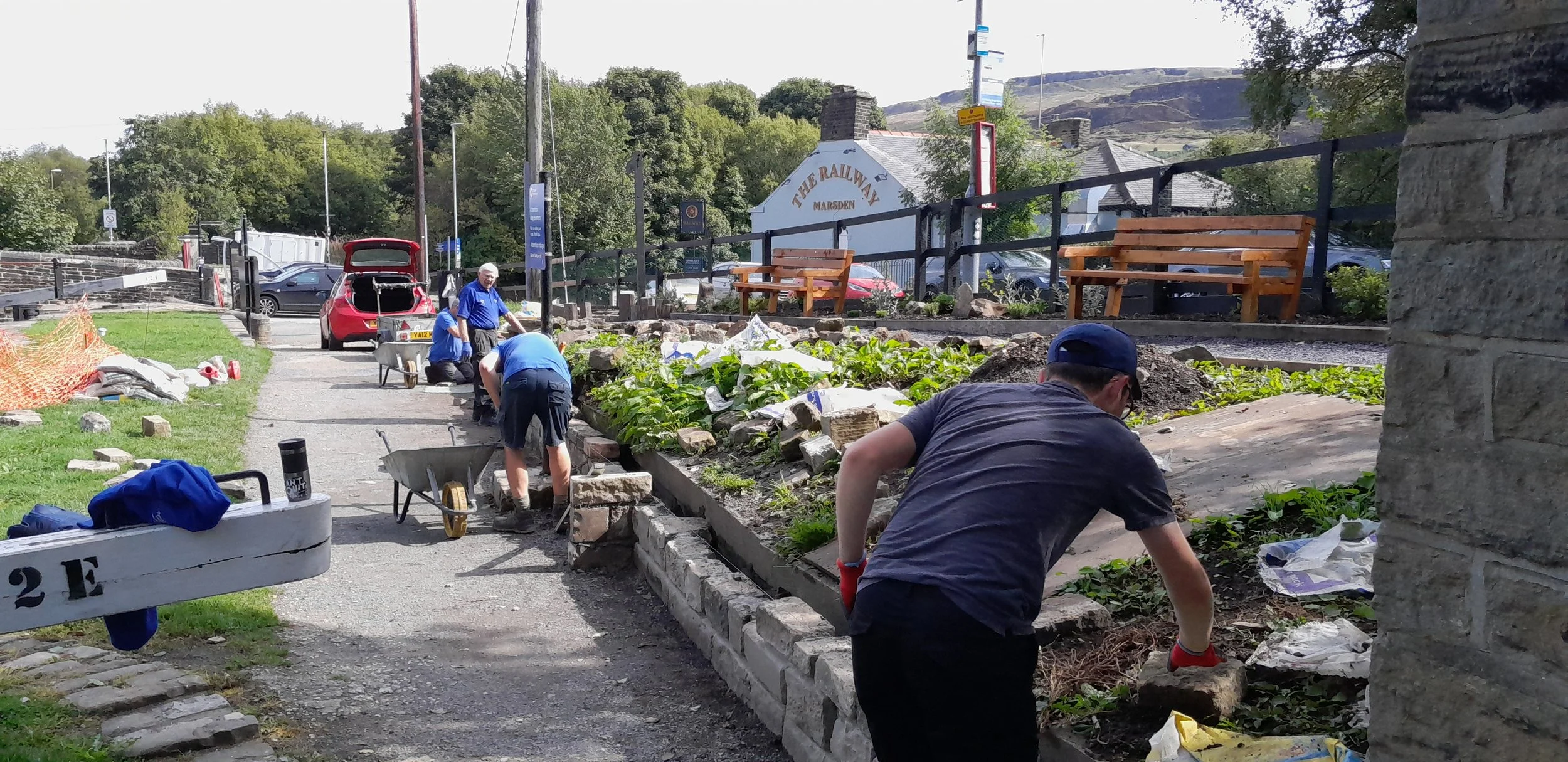 Canal and River Trust volunteers working on a community garden space in Marsden, West Yorkshire.
