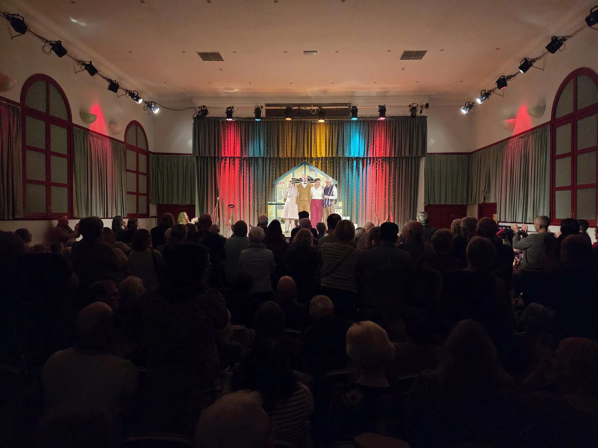 Actors on stage in a Mikron Theatre performance in the Marsden Mechanics main hall.