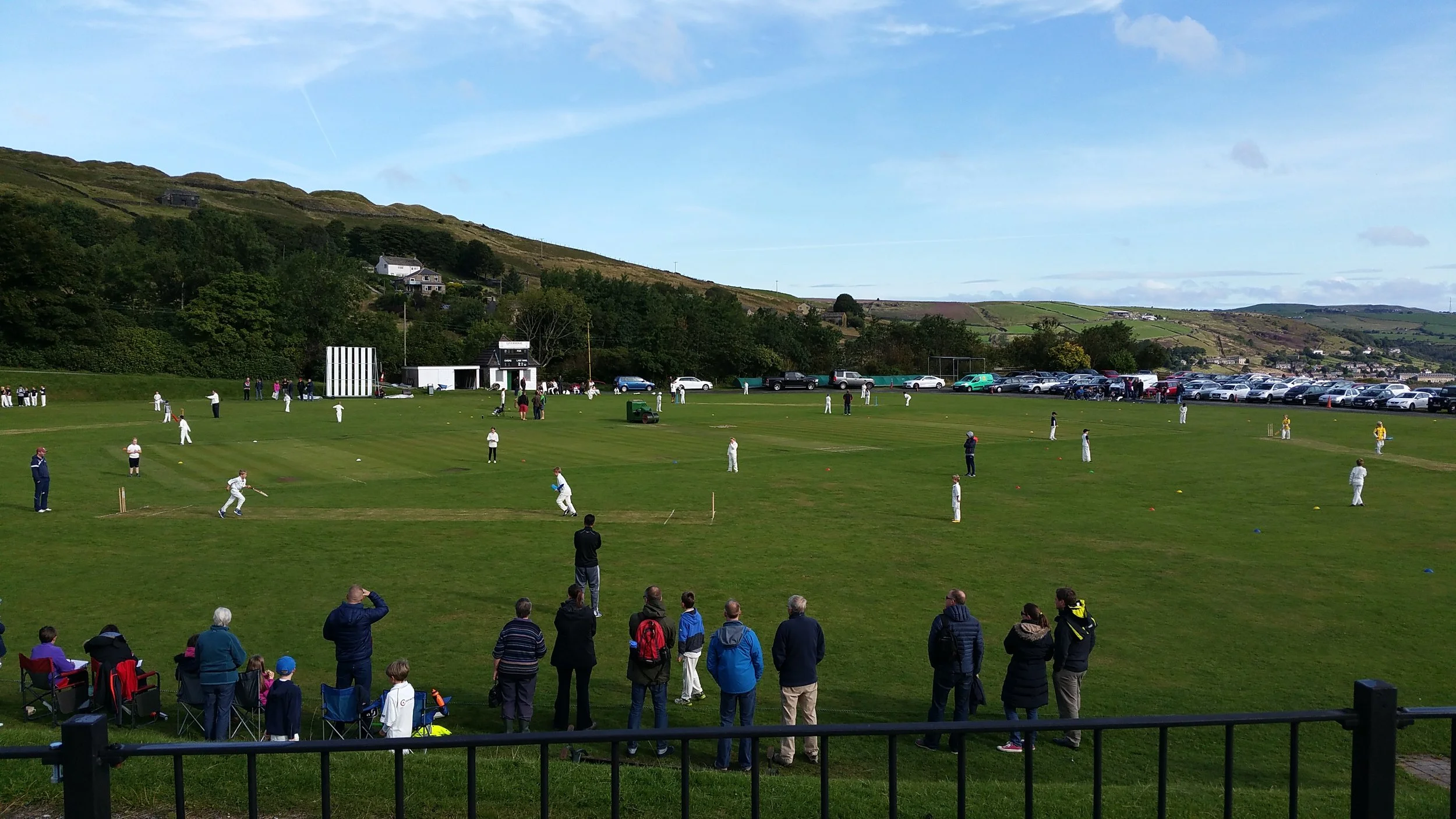 A cricket match taking place at Marsden Cricket Club in West Yorkshire.