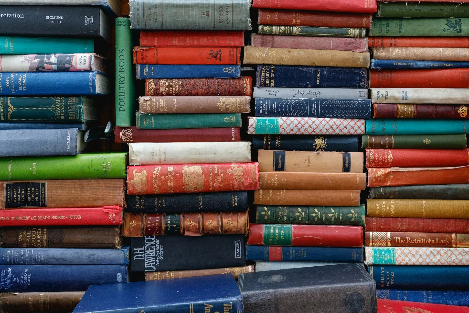 Lots of books piled up on top of each other.