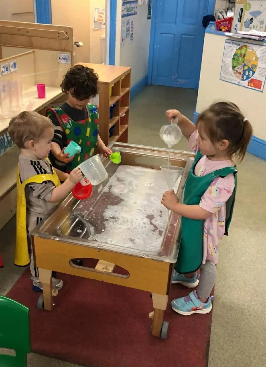 Water play at the Marsden Pre-School Playgroup in Marsden, West Yorkshire.