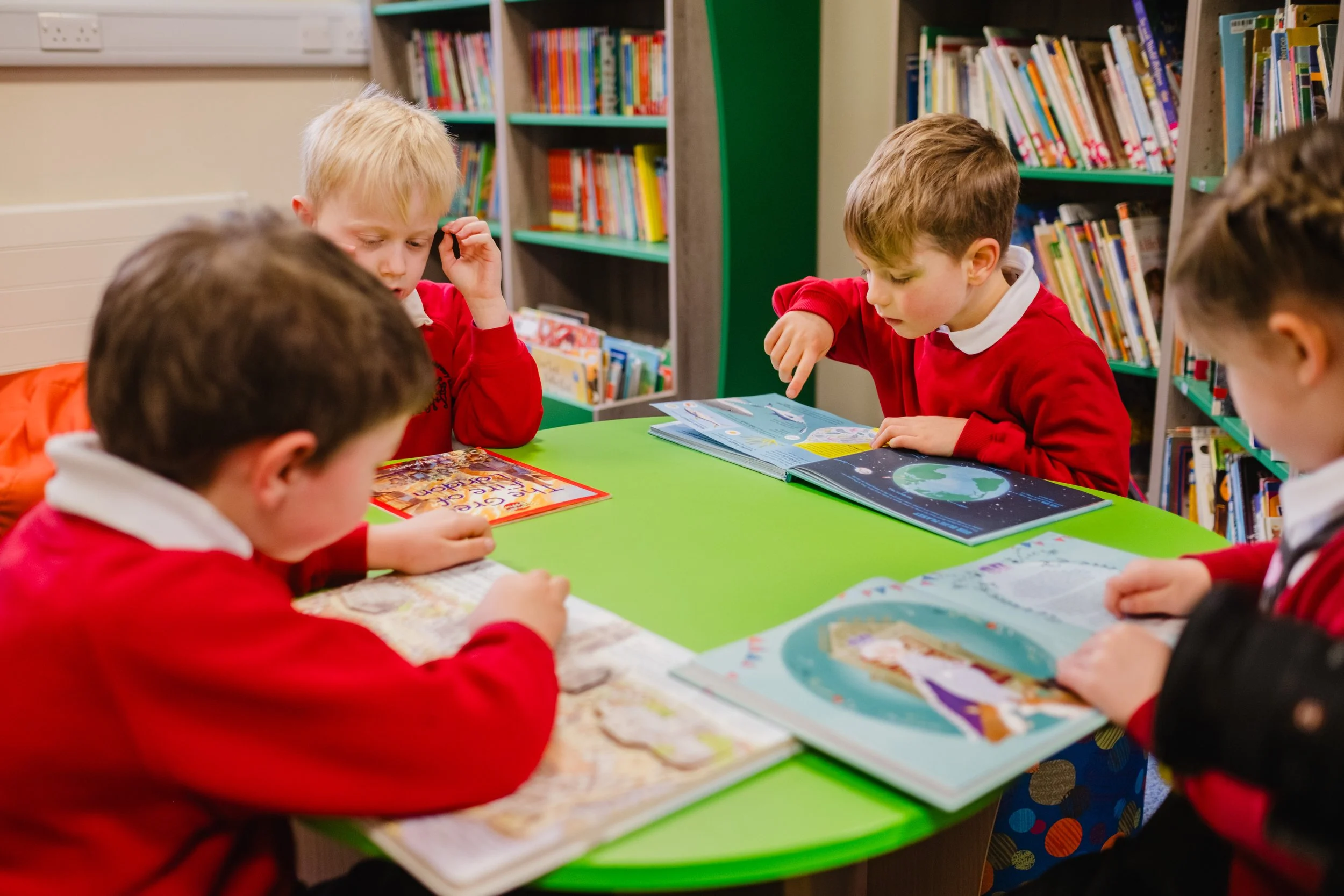 Students working around a table at Marsden Infant and Nursery School, West Yorkshire.