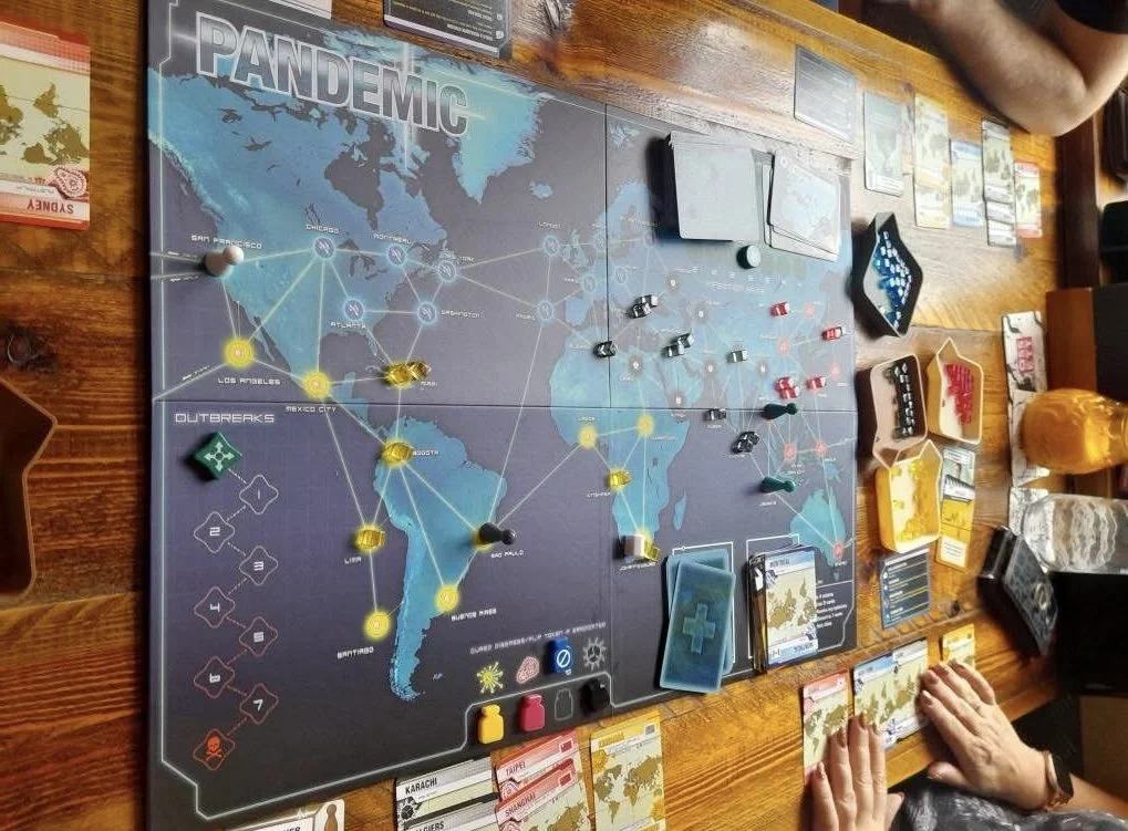 Members of the Marsden Board Gamers group sitting and playing a board game.