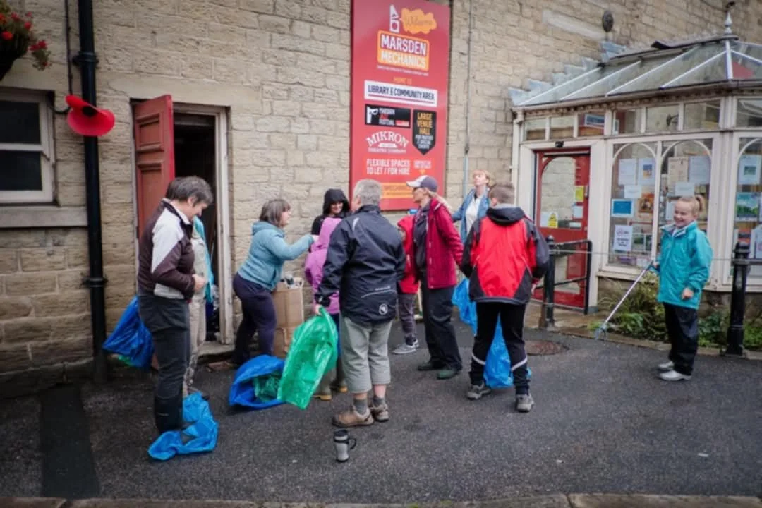 Volunteer litter pickers during a community action day in Marsden, West Yorkshire.