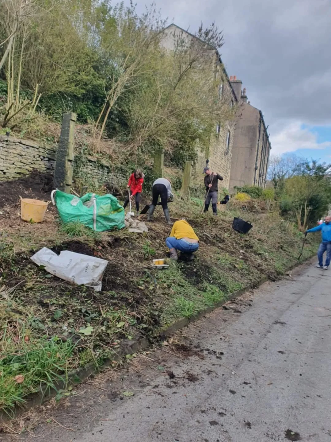 Volunteer gardeners tidying communal areas in Marsden, West Yorkshire.