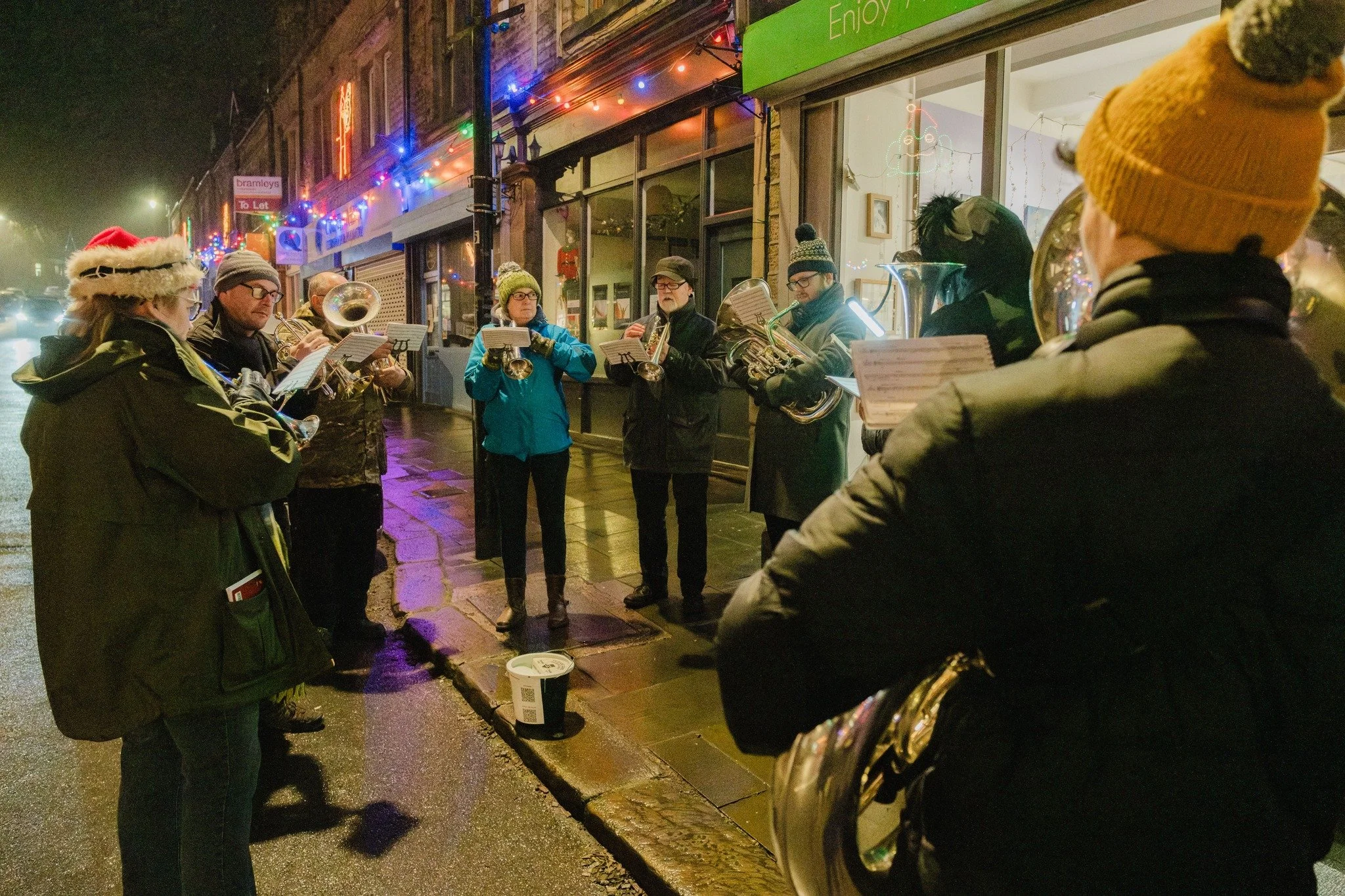 Members of the Marsden Silver Prize Band playing carols during a late-night shopping event in Marsden, West Yorkshire.