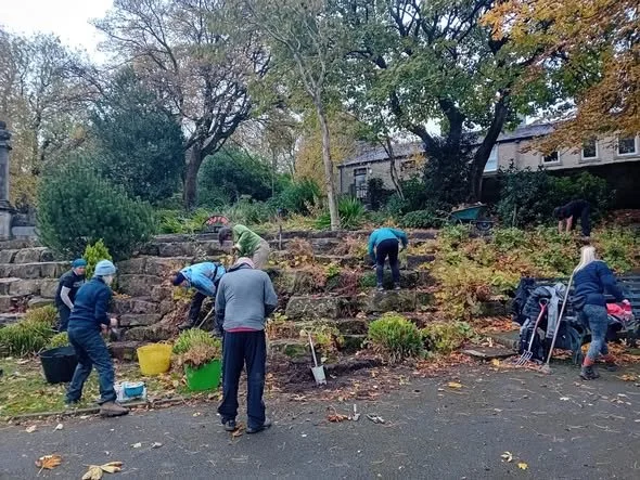 Volunteers helping tidy up Marsden park in Marsden, West Yorkshire.