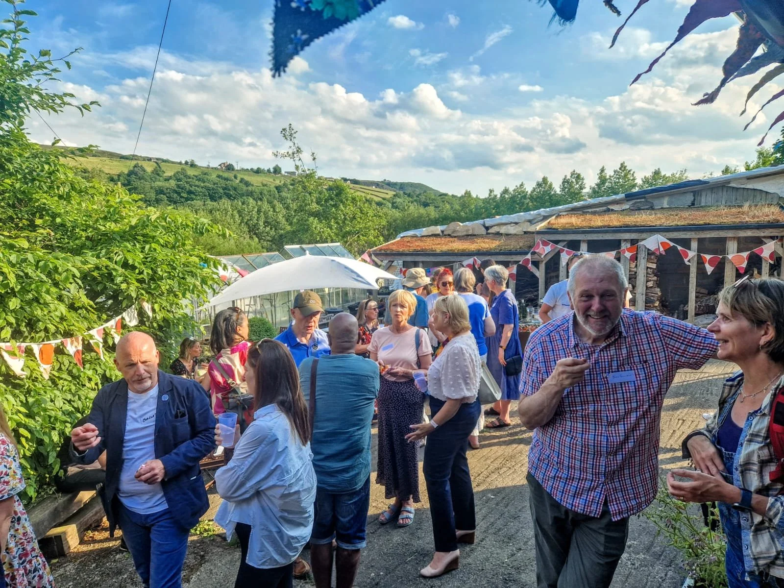 People gathered for an event held at Edibles, a permaculture smallholding and event space.