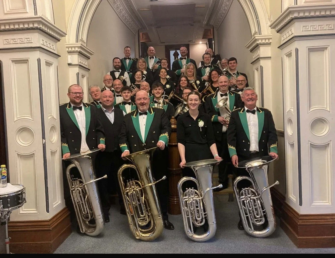 Members of the Marsden Silver Prize Brass Band assembled in their uniforms.