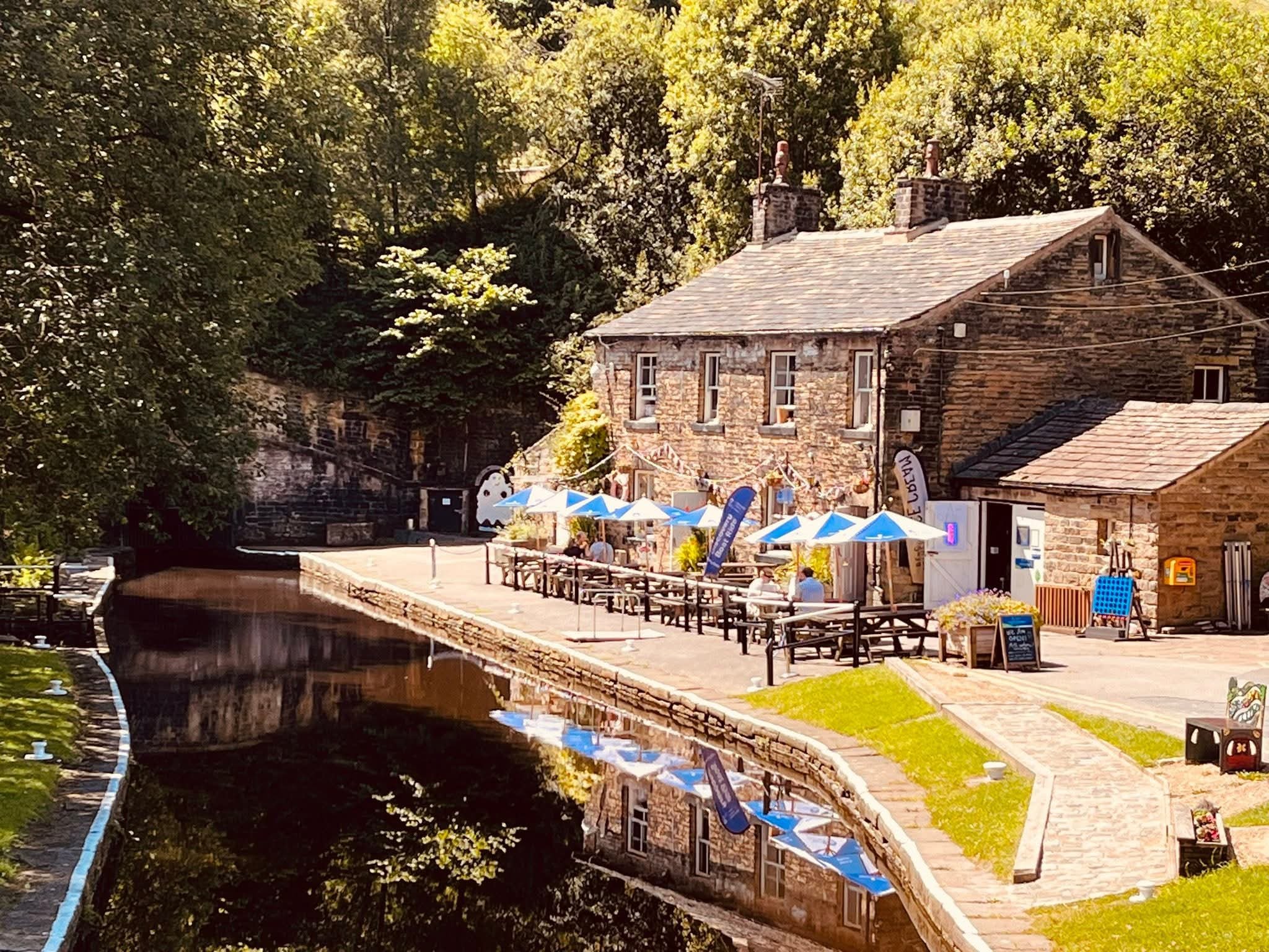 The seating area by the canal outside the Watersedge Cafe at Tunnel End in Marsden, West Yorkshire.