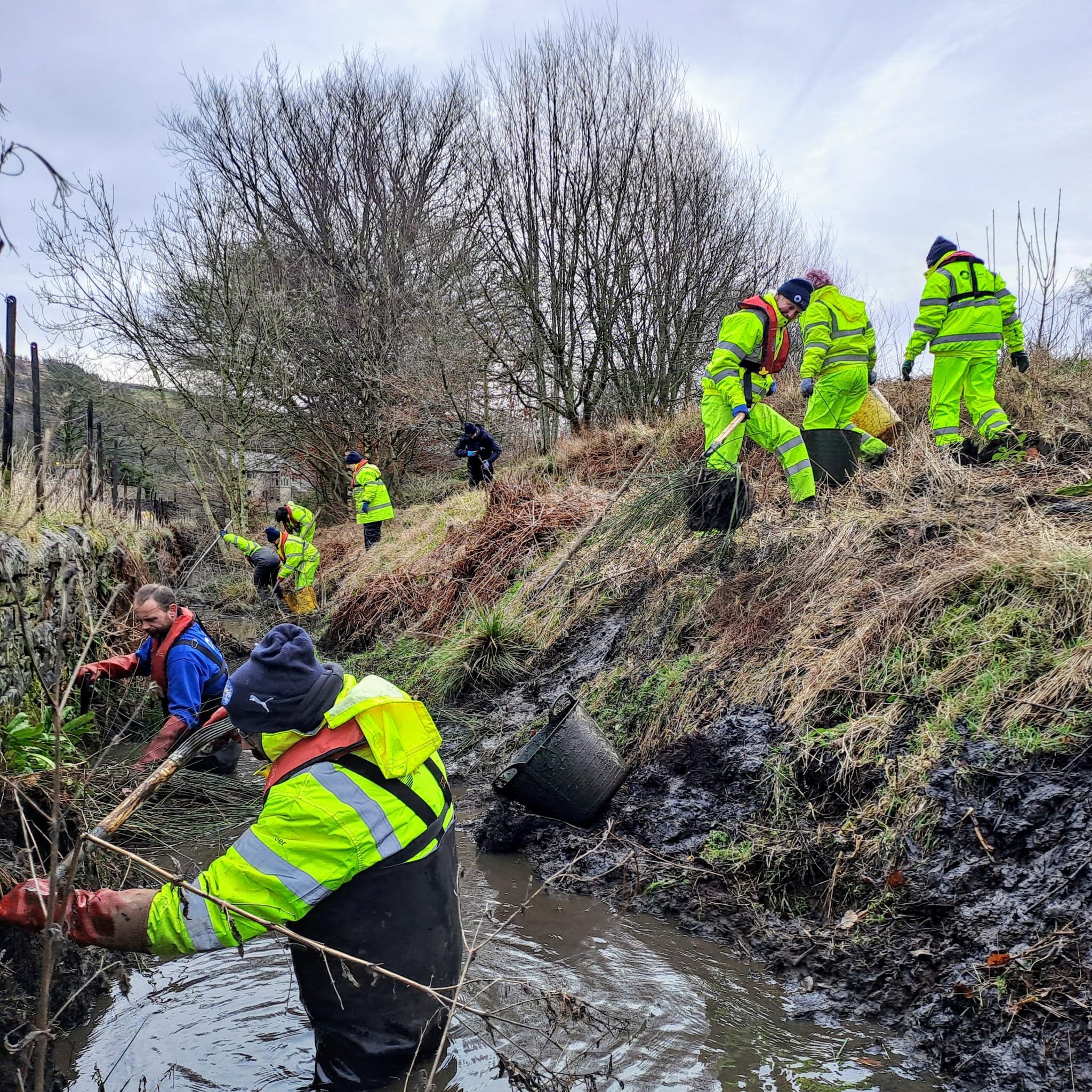 A team of Canal and River Trust volunteers at work in Marsden, West Yorkshire.