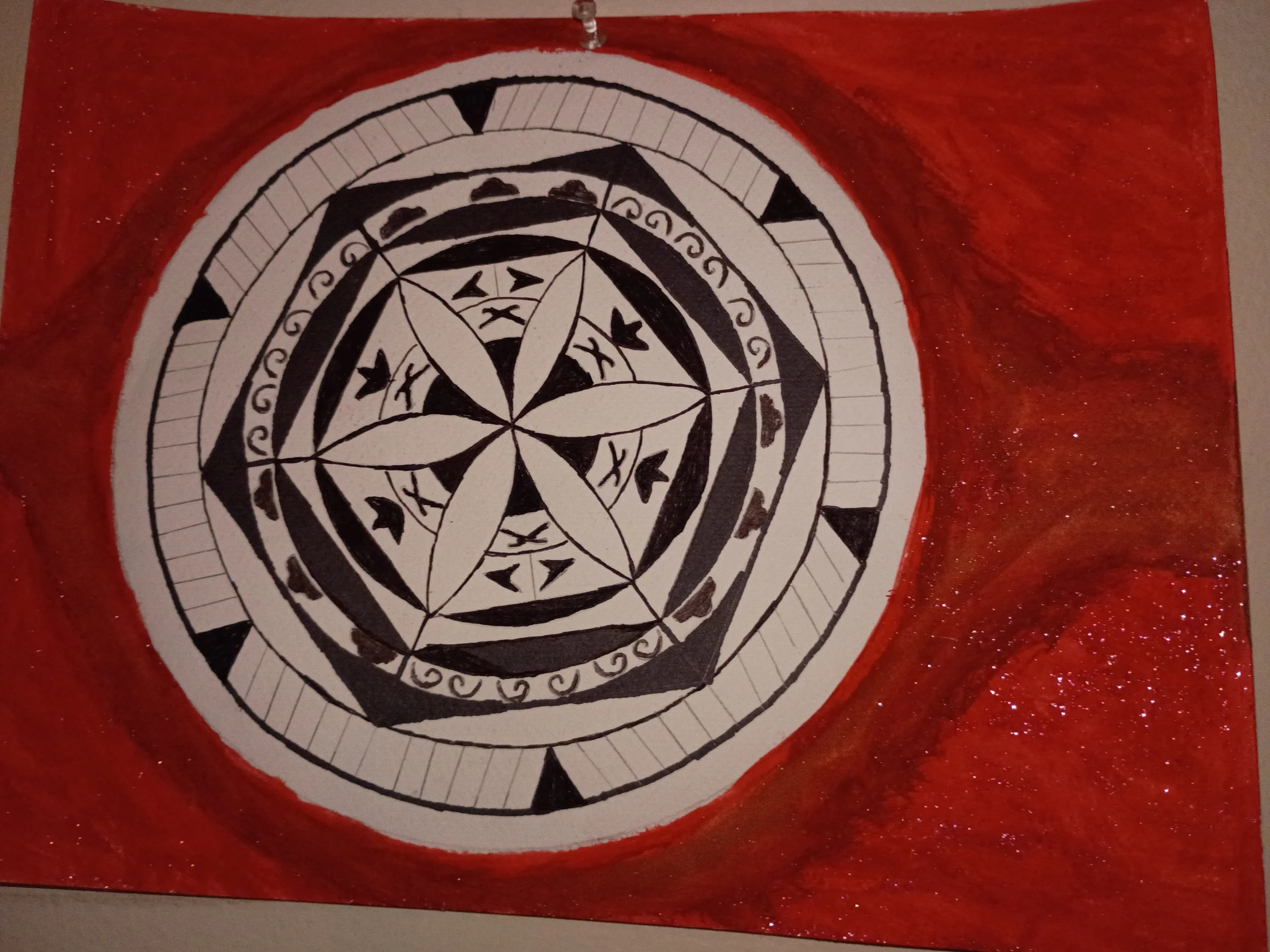 Pencil, pen, paint and glitter. This flower was made with a compass and some stencils. 