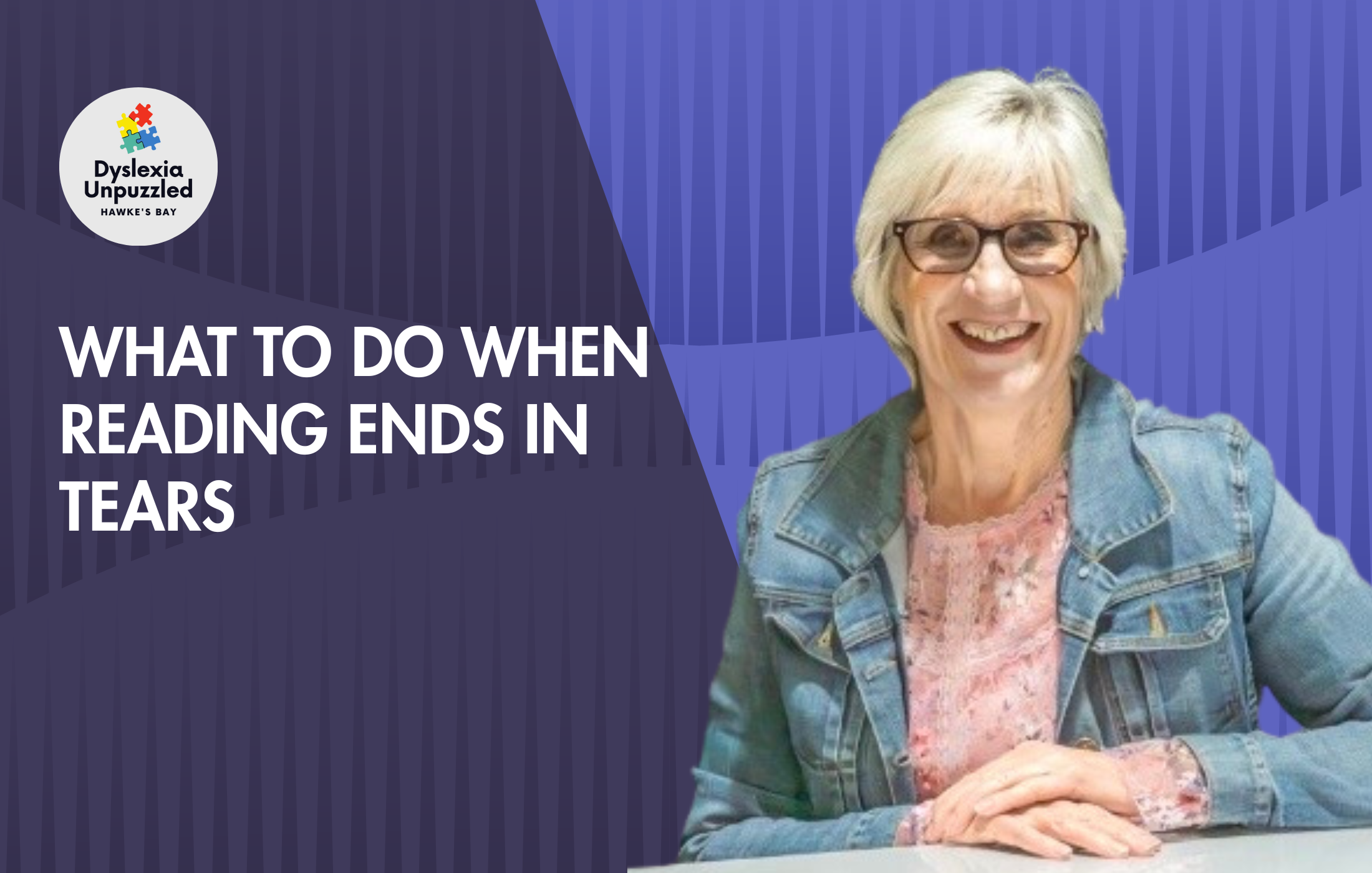 Smiling elderly woman with glasses and short gray hair sitting at a table, wearing a denim jacket and pink floral blouse, promoting a Dyslexia Unpuzzled event in Hawke's Bay.