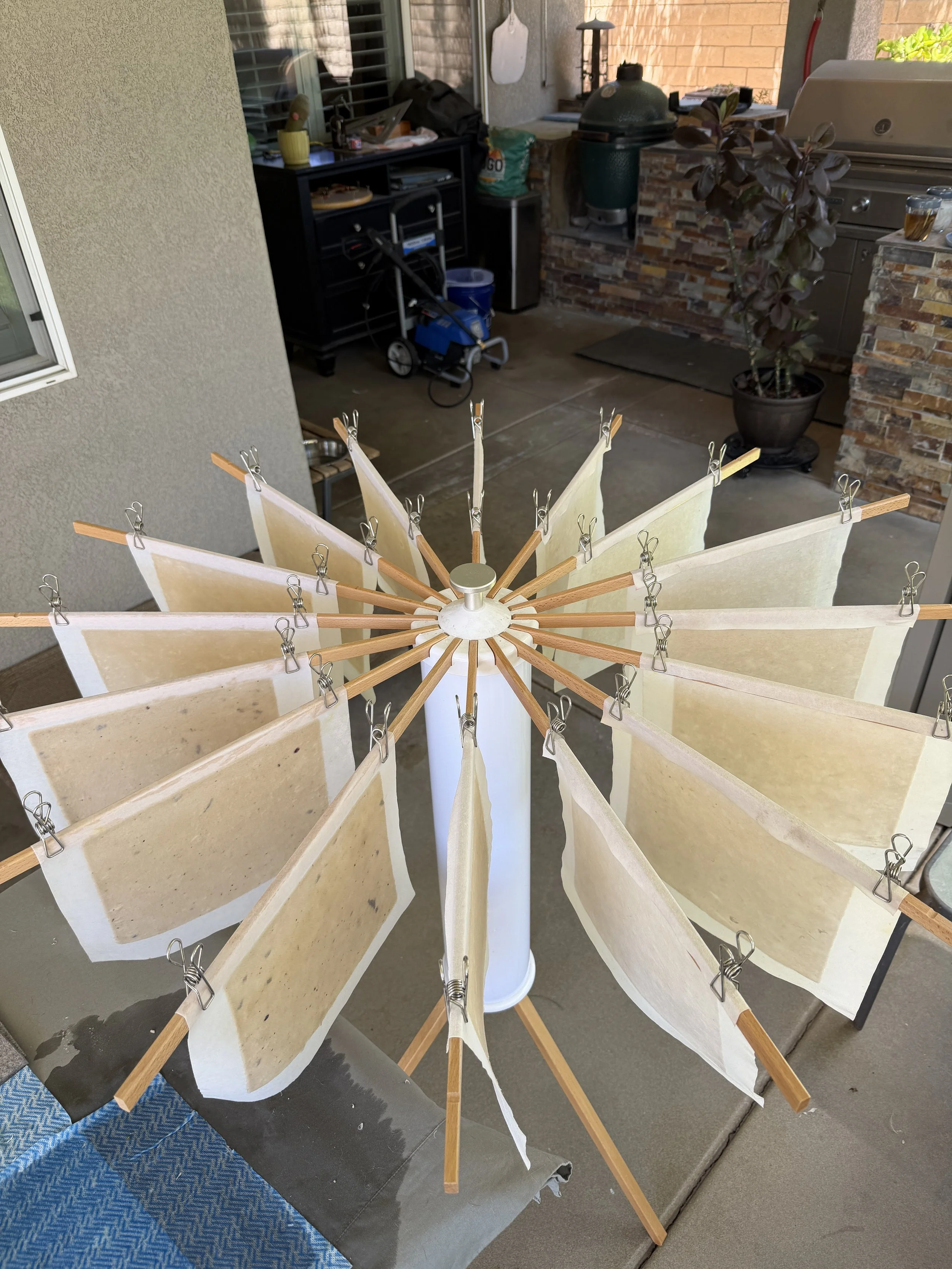 Handmade memorial paper drying after being formed from natural fibers and meaningful keepsakes.