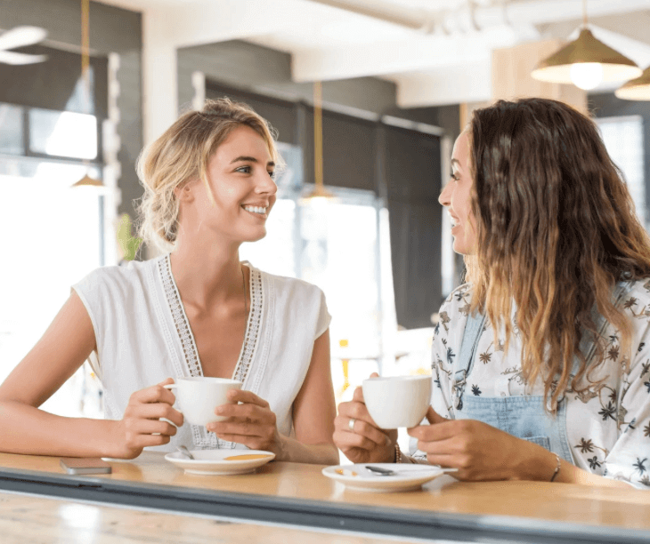 Two ladies talking over a cup of coffee