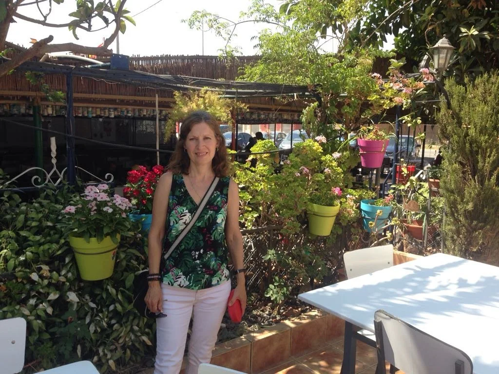 A portrait of Saguna Katarina Tilley on the About page, detailing her background, spiritual lineage, and qualifications as a meditation teacher and Reiki Master.