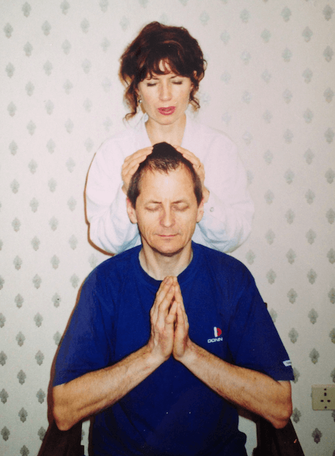 Saguna Katarina Tilley passing a sacred attunement to a student during a Reiki Master course training course in Essex.png