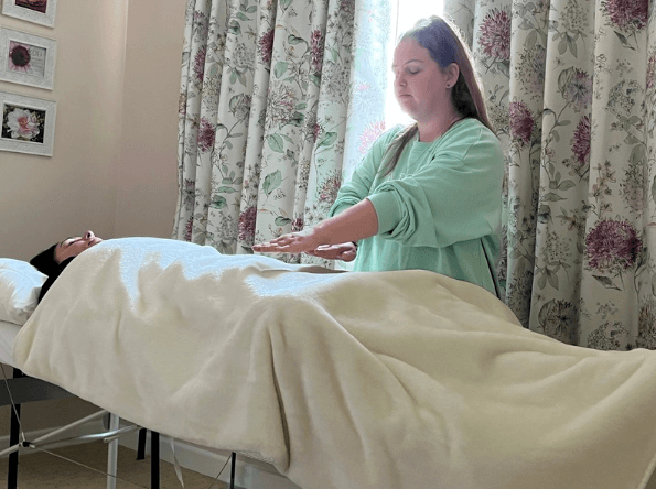 Course participant channeling Usui healing energy during a Reiki Level 2 training class in Clacton