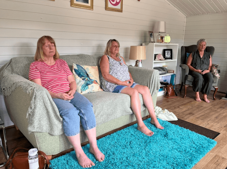Three women meditating peacefully together, illustrating group sessions for the Mindfulness Meditation Course at the Katarina Tilley Meditation Centre in Clacton-on-Sea, Essex.
