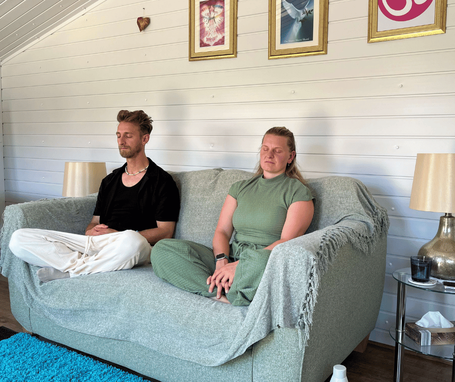 A man and a woman sitting cross-legged and meditating together, representing group sessions for the Mindfulness Meditation Course at the Katarina Tilley Meditation Centre in Clacton-on-Sea, Essex.