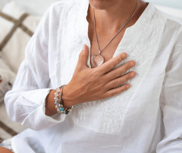 An illustration of a woman focusing on the heart chakra, representing the upcoming dates for the monthly spiritual group with Katarina Tilley