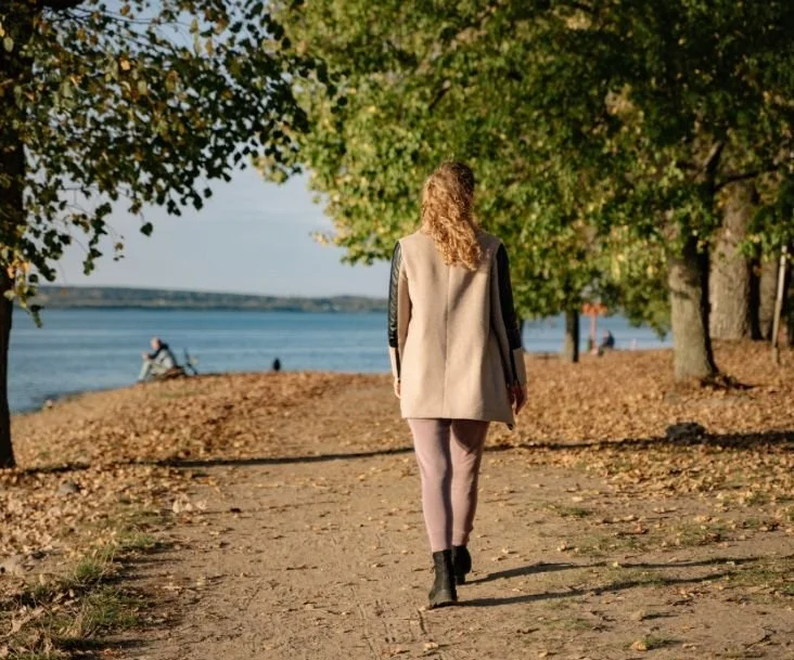 A woman practicing mindful walking meditation outdoors, hosted by the Katarina Tilley Meditation Centre within easy reach of Harwich.
